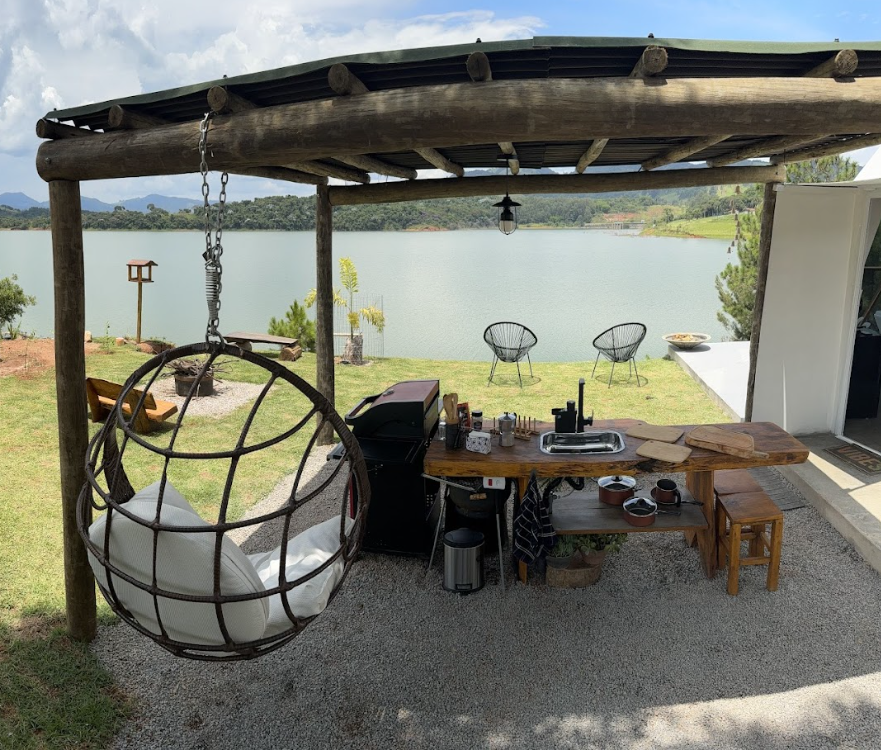 Vista interna completa da Casa Bolha com mesa, jacuzzi e paisagem